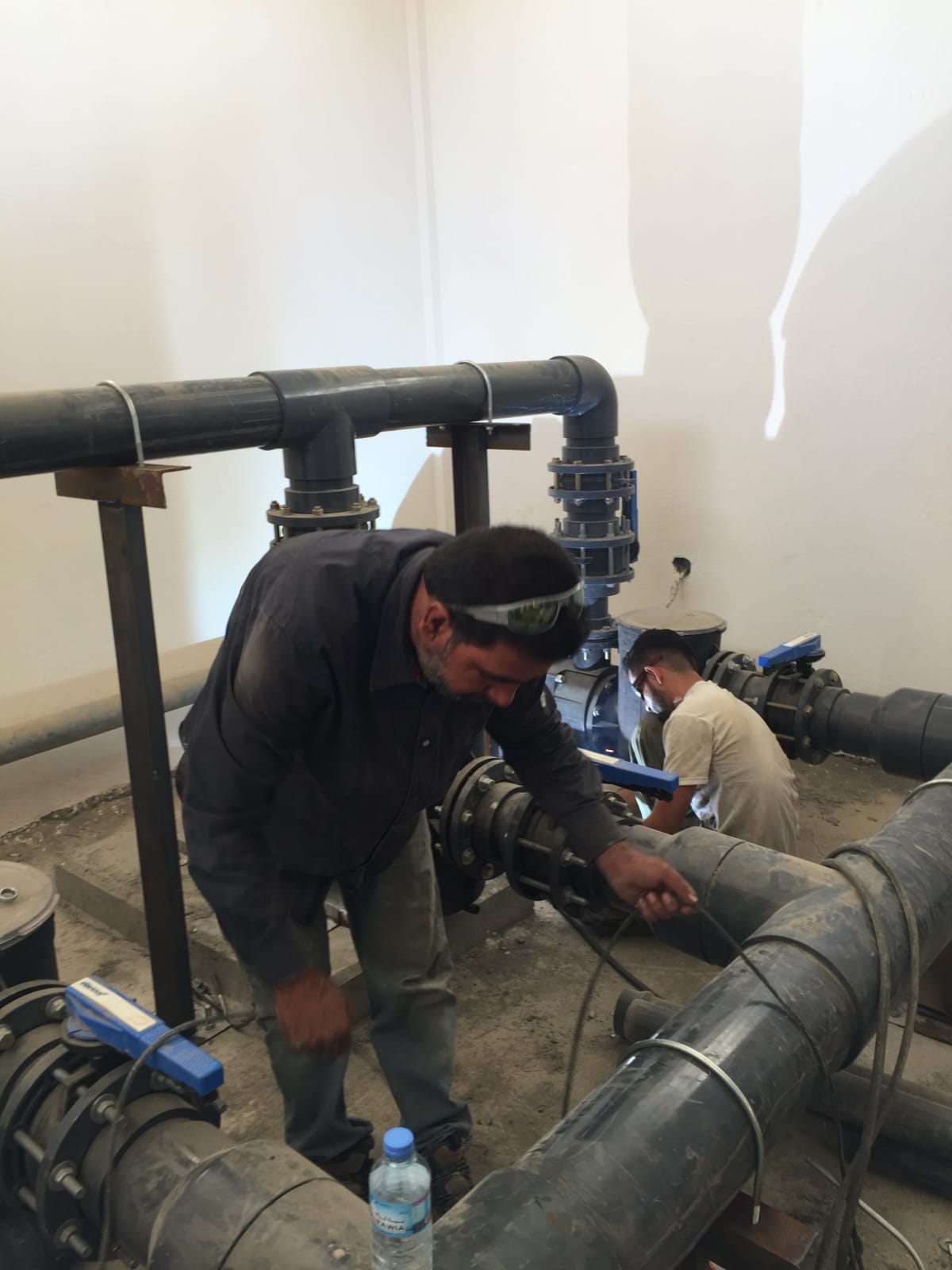 Engineers and technicians performing maintenance on industrial machinery