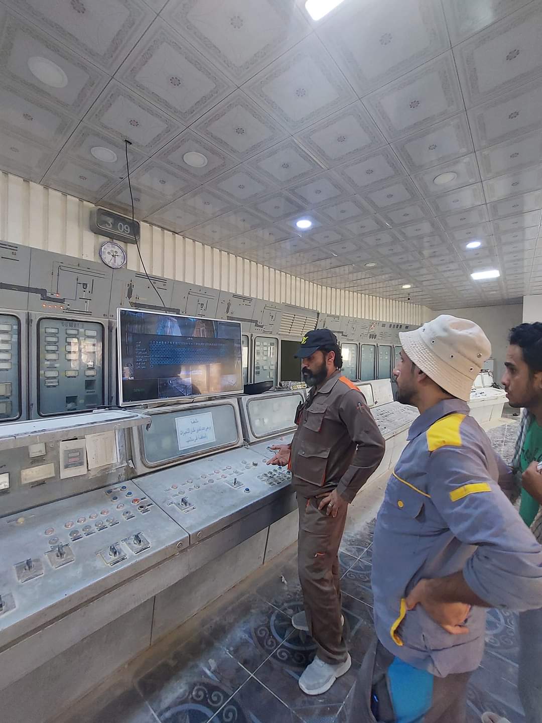 Engineers reviewing production line plans on the factory floor